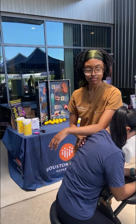 Holly O'Neal providing chair massage at a community health event